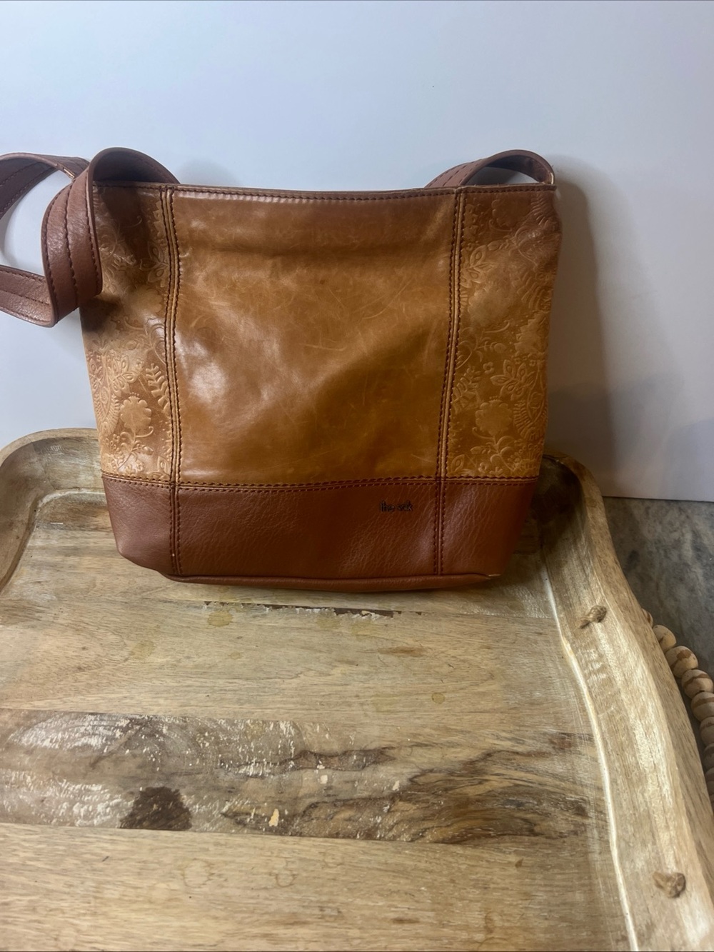 The Sak tan leather crossbody with beige interior